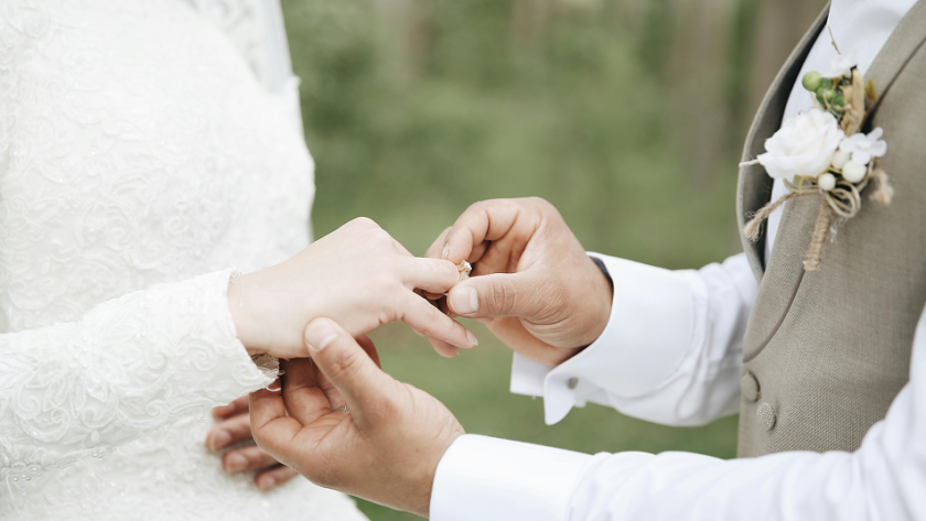 Bride and groom exchanging wedding rings during a ceremony at Three Willows Ranch Colorado