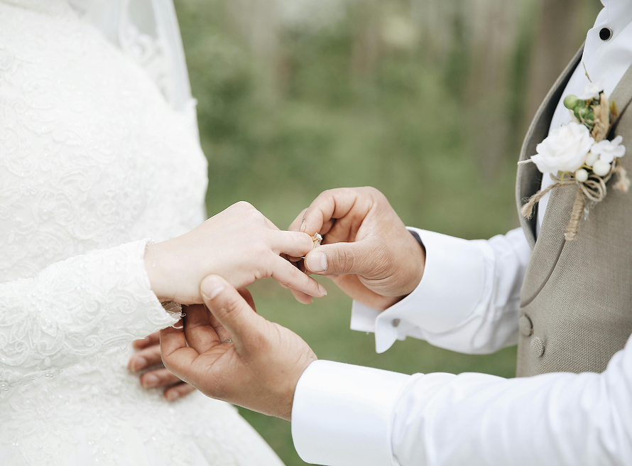 Bride and groom exchanging wedding rings during a ceremony at Three Willows Ranch Colorado