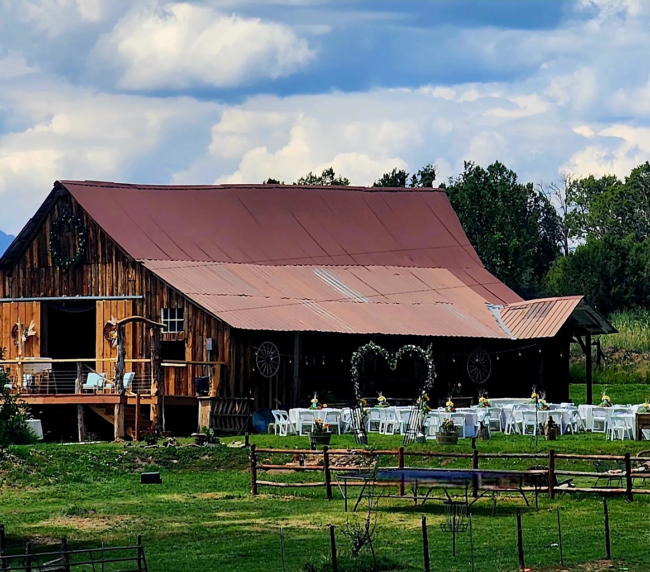 Rustic barn wedding venue with outdoor ceremony setup at Three Willows Ranch in Colorado