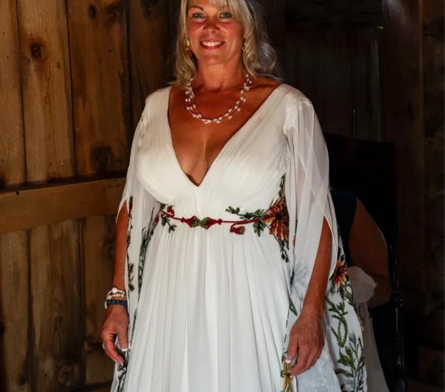 Bride walking inside the rustic barn at Three Willows Ranch wedding venue in Colorado