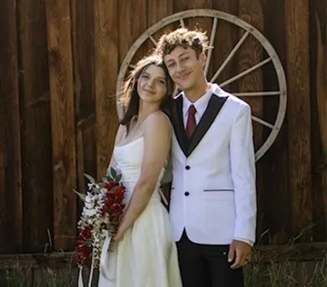 Bride and groom posing in front of a rustic barn wall at Three Willows Ranch wedding venue in Colorado