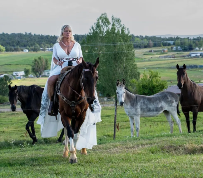 Bride in a white wedding dress riding a horse in the countryside near Three Willows Ranch wedding venue in Colorado