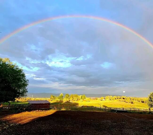 Beautiful rainbow over the countryside landscape at Three Willows Ranch in Colorado