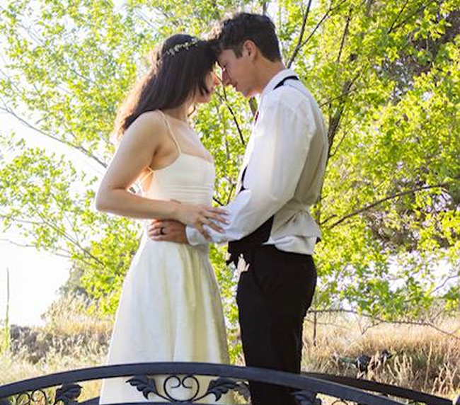 Bride and groom on garden bridge at Three Willows Ranch outdoor wedding venue in Bayfield Colorado