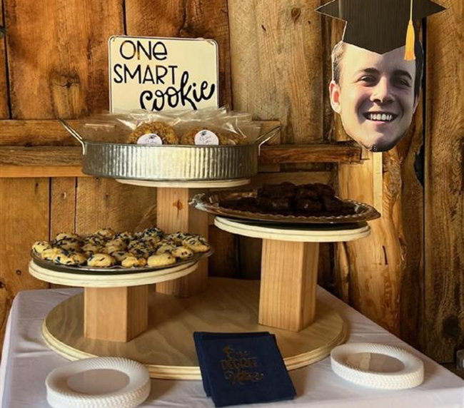 Graduation dessert table with cookies and decor at a rustic ranch venue in Bayfield Colorado, styled for a memorable celebration.