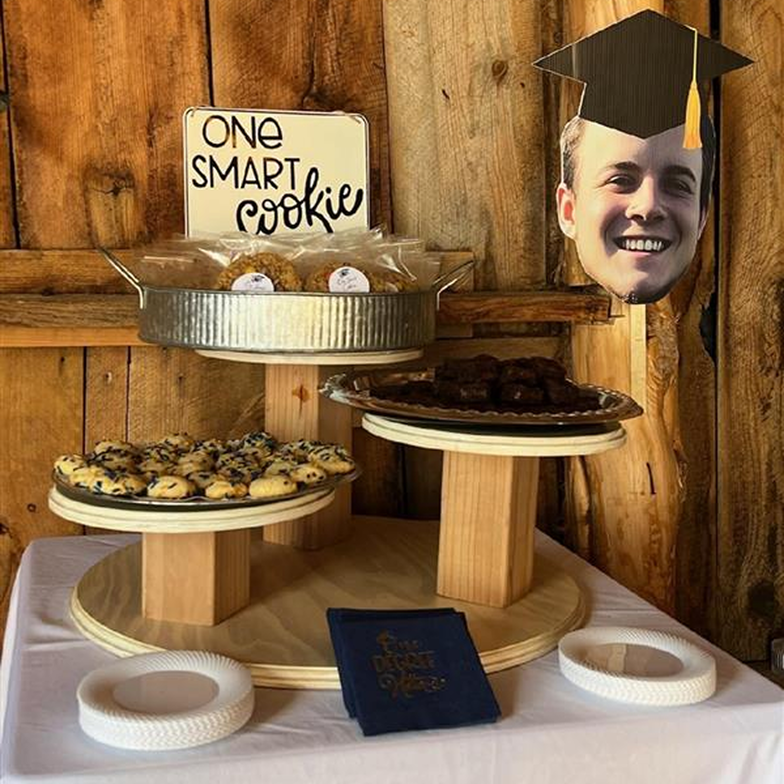 Graduation dessert table with cookies and decor at a rustic ranch venue in Bayfield Colorado, styled for a memorable celebration.