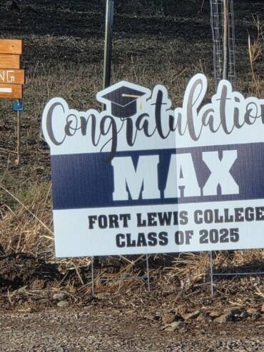Graduation yard sign with event parking directions at a scenic ranch in Bayfield Colorado, welcoming guests to a celebration.