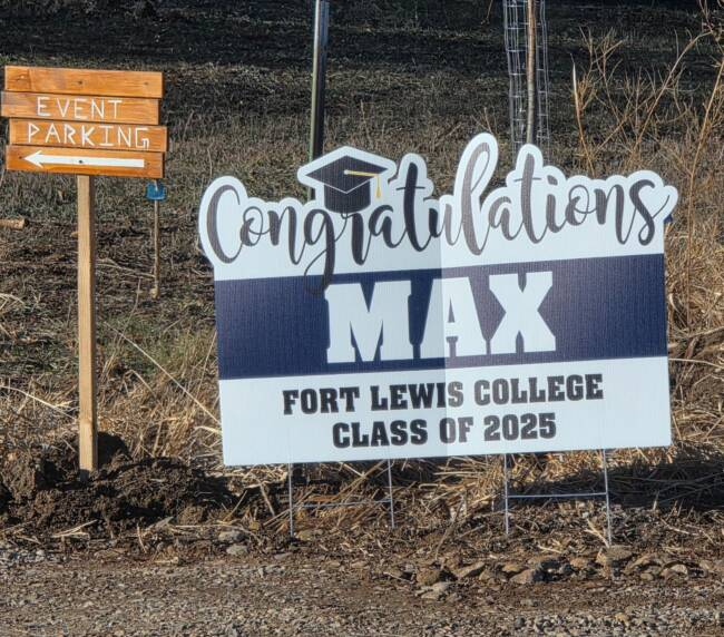 Graduation yard sign with event parking directions at a scenic ranch in Bayfield Colorado, welcoming guests to a celebration.