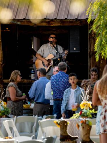 Live acoustic music performance during an outdoor event at Three Willows Ranch rustic barn venue in Bayfield Colorado