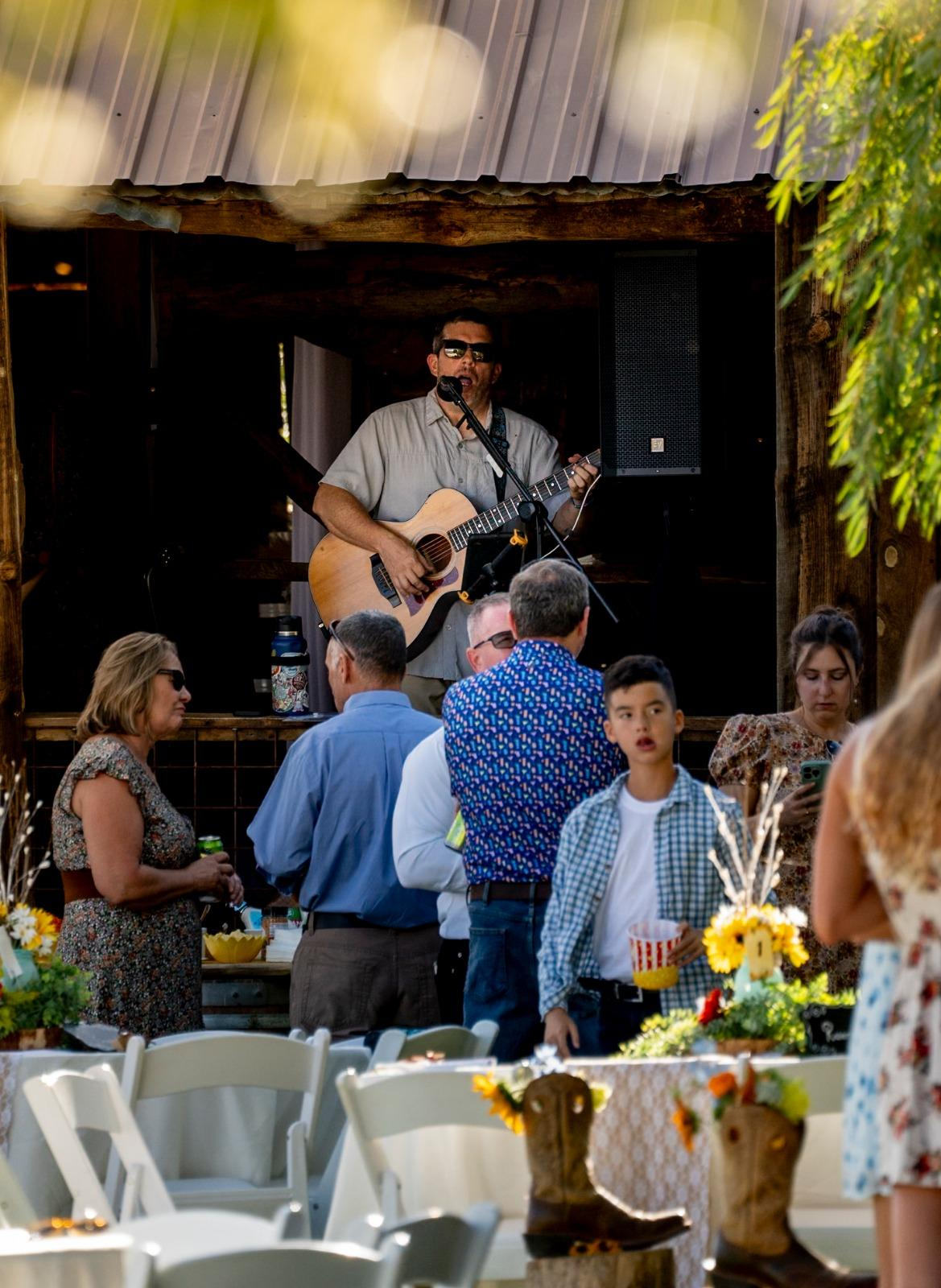 Live acoustic music performance during an outdoor event at Three Willows Ranch rustic barn venue in Bayfield Colorado