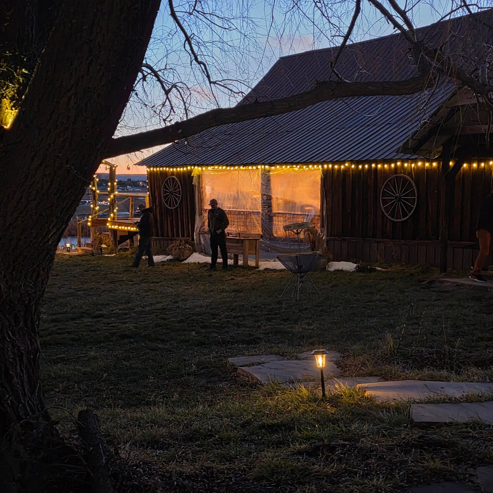 Rustic barn at Three Willows Ranch illuminated with warm lights during an evening event