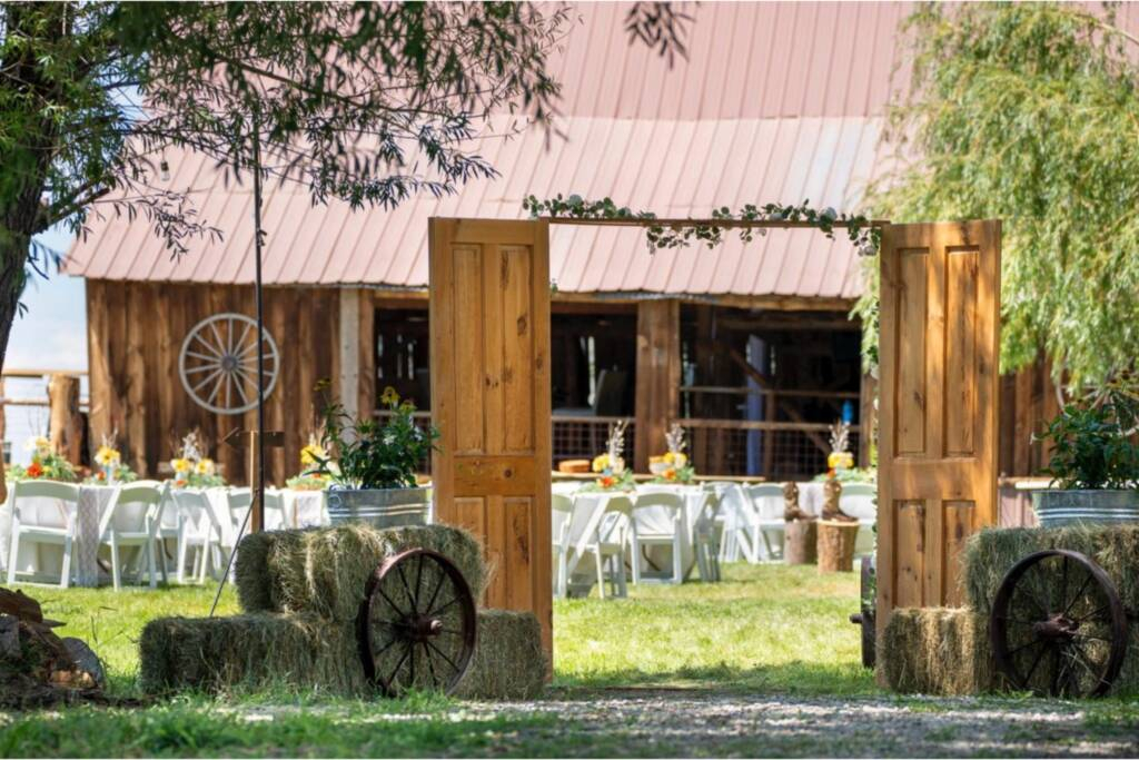 Rustic wedding entrance with wooden doors and barn reception setup at Three Willows Ranch Colorado