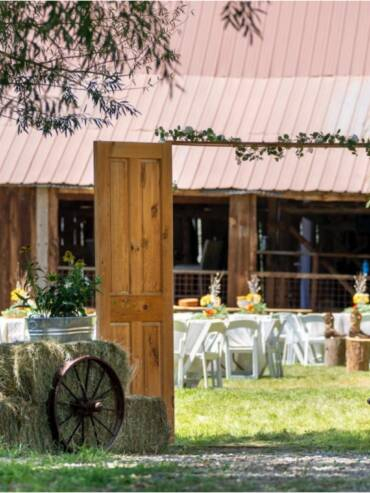 Rustic wedding entrance with wooden doors and barn reception setup at Three Willows Ranch Colorado