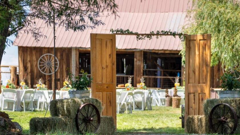 Rustic wedding entrance with wooden doors and barn reception setup at Three Willows Ranch Colorado