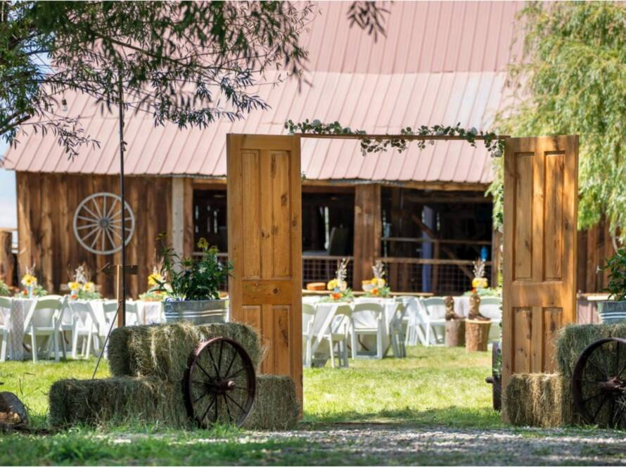 Rustic wedding entrance with wooden doors and barn reception setup at Three Willows Ranch Colorado