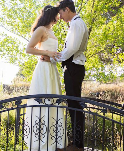Bride and groom on garden bridge at Three Willows Ranch outdoor wedding venue in Bayfield Colorado