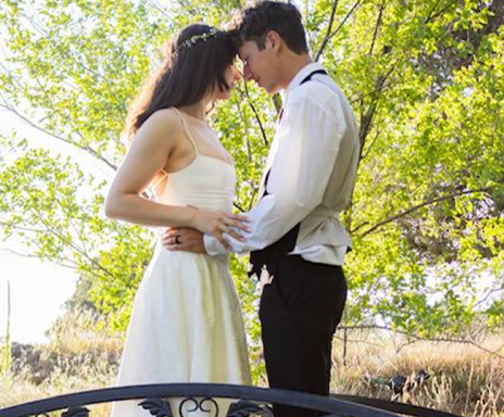 Bride and groom on garden bridge at Three Willows Ranch outdoor wedding venue in Bayfield Colorado